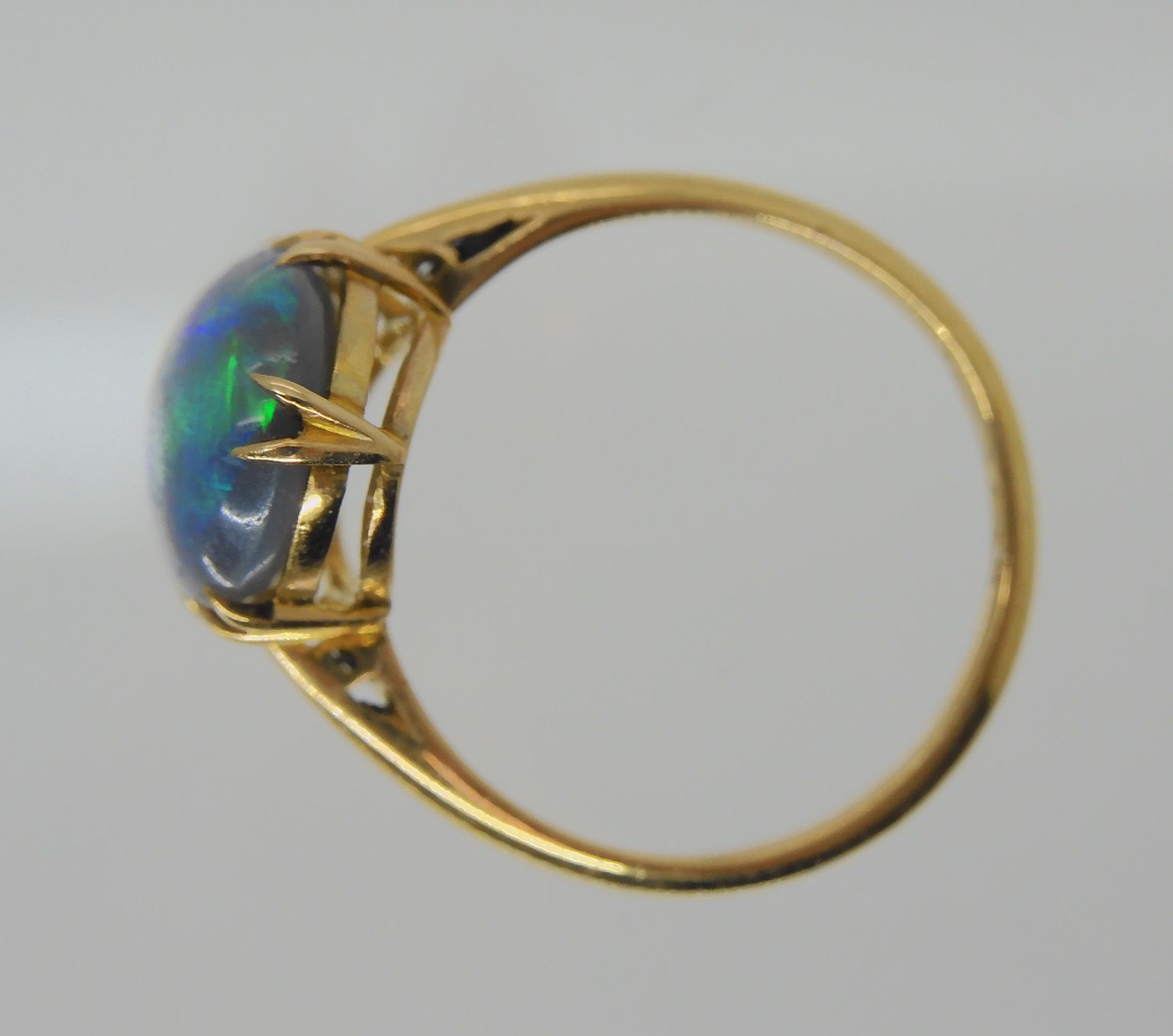 AN OPAL RING AND OTHER ITEMS The solid black opal has lively green, purple and blue colour play, and - Image 7 of 15