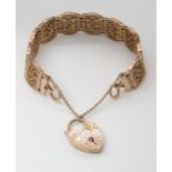 A 9CT GATE BRACELET with an engraved heart shaped clasp, and decorative patterned links, length