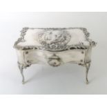AN EDWARDIAN SILVER JEWELLERY BOX by William Comyns, Birmingham 1902, in the form of a rococo table,