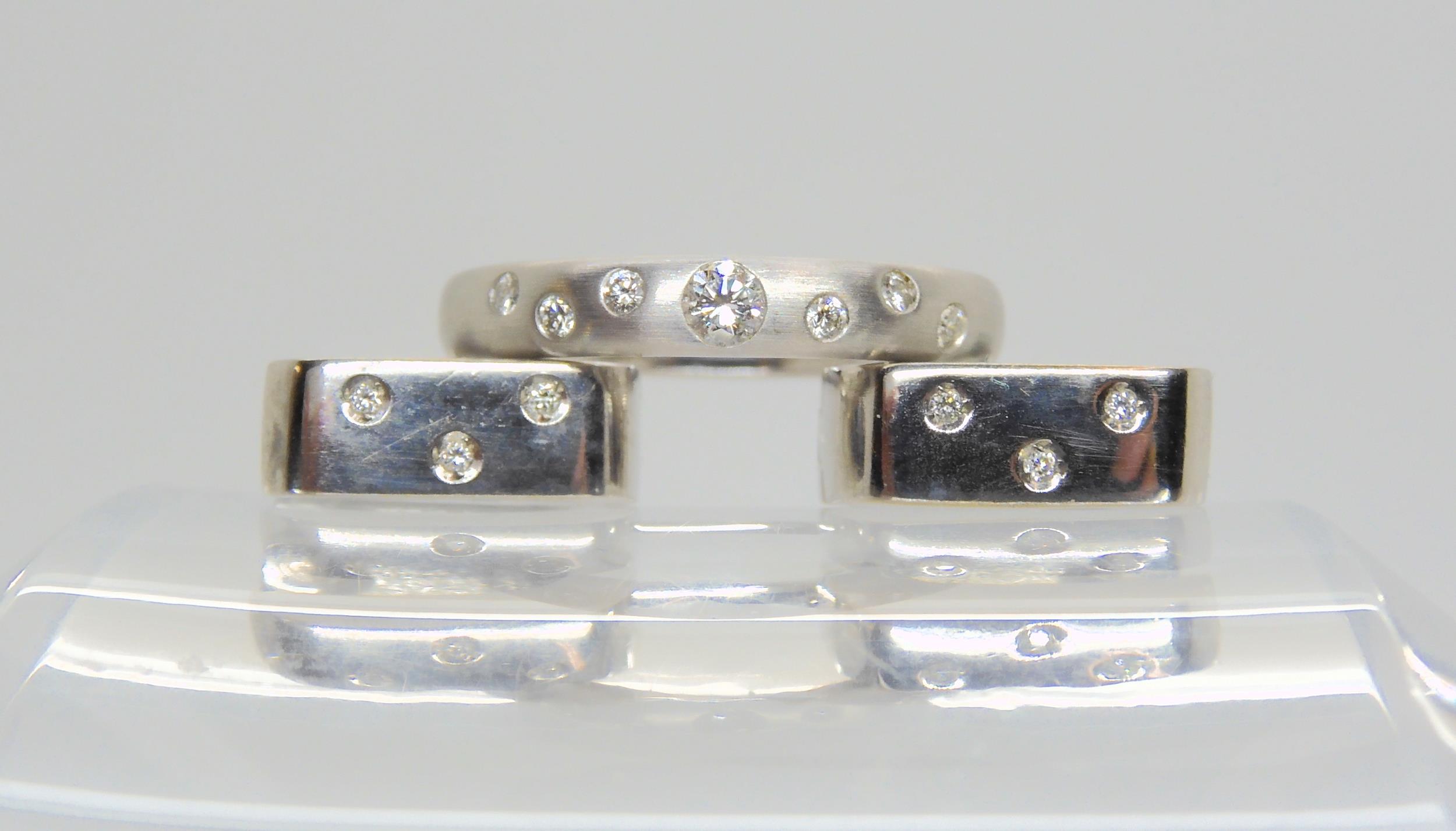 AN 18CT WHITE GOLD DIAMOND DOT RING the brushed textured surface set with seven brilliant cut