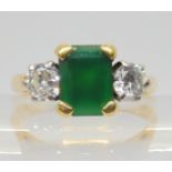 AN EMERALD AND DIAMOND RING the 18ct gold ring set with a step cut emerald 8mm x 6mm, and two