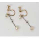 A PAIR OF PEARL & DIAMOND EARRINGS mounted in yellow 9ct gold and white metal, the pearl studs to