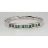 AN 18CT GOLD EMERALD AND DIAMOND BANGLE made by Lime Blue, full London import marks. with a