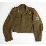 A WW2 POLISH 2ND CORPS BATTLEDRESS BLOUSE In khaki wool serge, with epaulettes bearing rank of