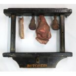 AN EARLY 20TH CENTURY BUTCHER'S SHOP CARVED WOOD WINDOW DISPLAY Largely black-painted, with