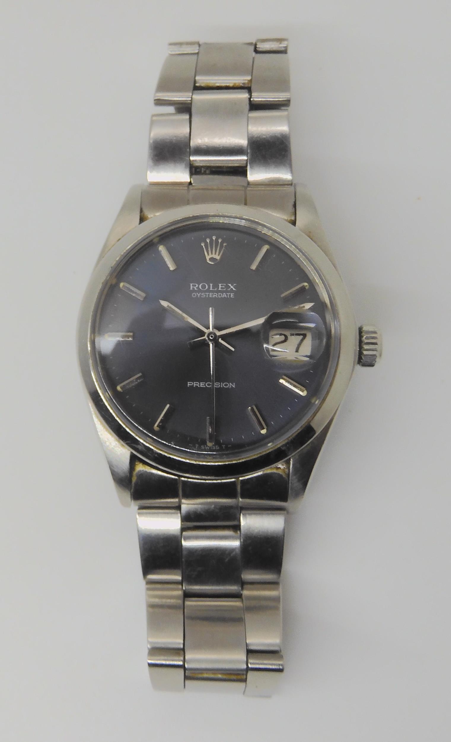 A ROLEX OYSTERDATE PRECISION with dark grey satined dial, silver coloured baton numerals, hands, and