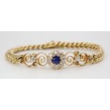 A SAPPHIRE AND DIAMOND FLOWER BRACELET set throughout in bright yellow metal, with diamond and