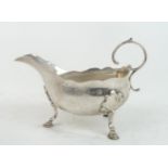 A GEORGE II SILVER SAUCE BOAT  London 1755, maker's mark SM, of helmet form, the body with an