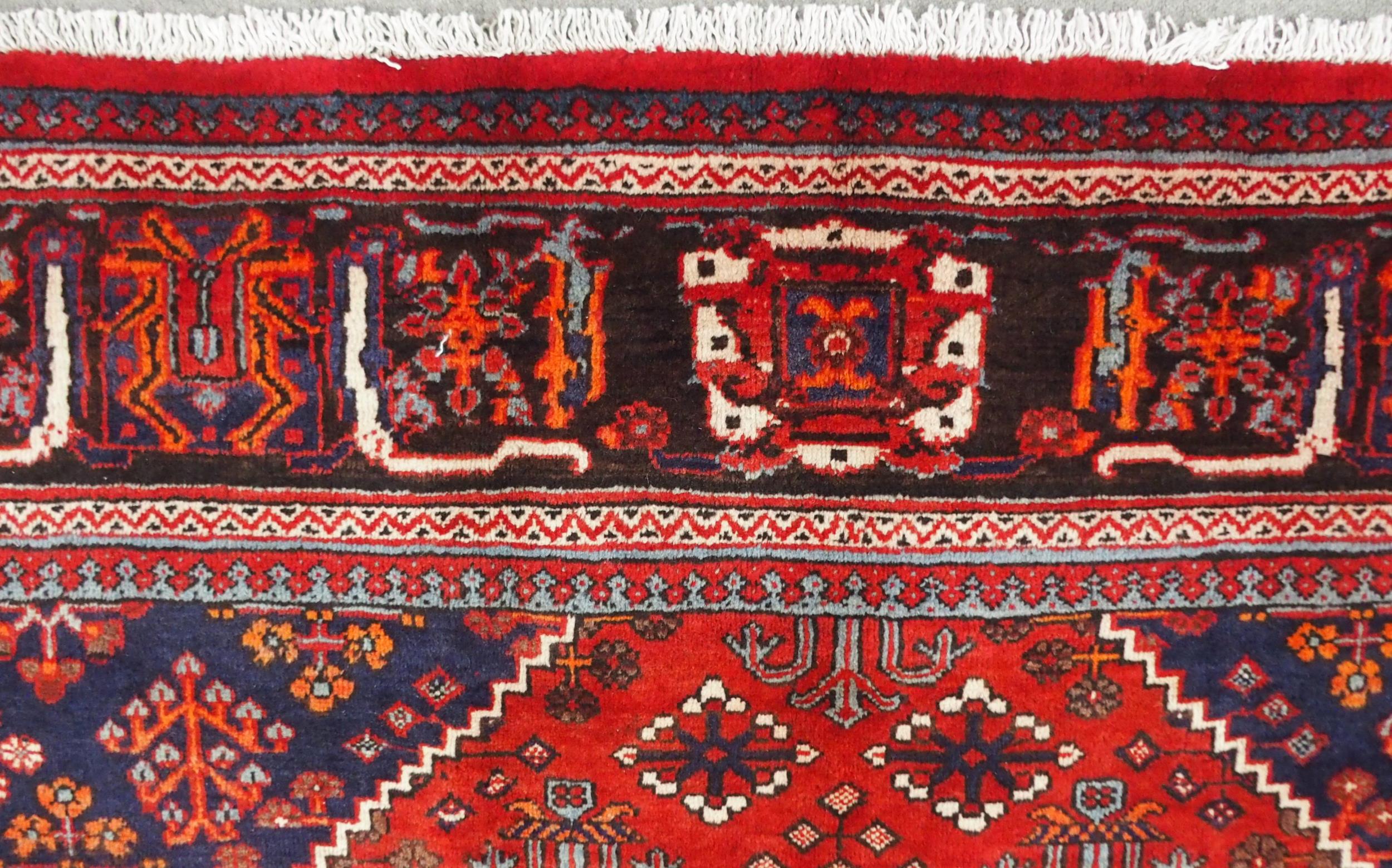 A RED GROUND MEIMEH RUG with dark blue central medallion, matching spandrels and dark blue flower - Image 8 of 10
