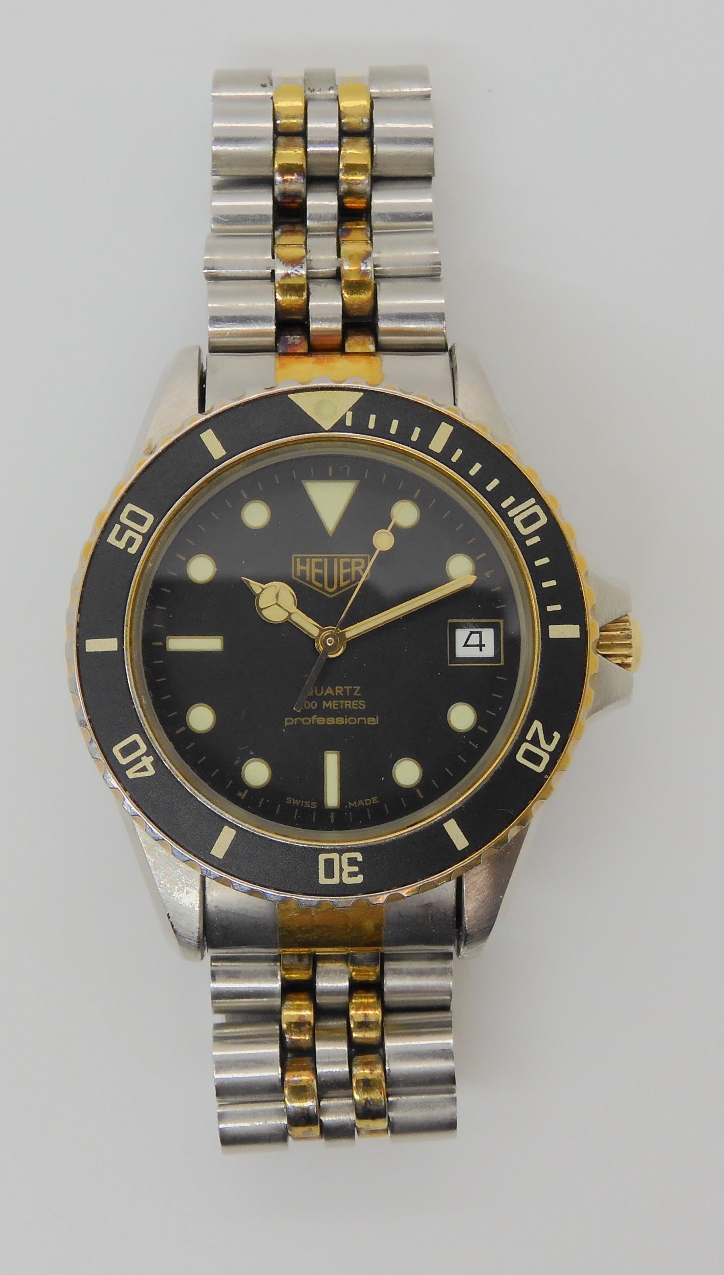 A VINTAGE HEUER WRISTWATCH circa 1983, steel and gold plate diver's watch.  The watch has a black - Image 2 of 11