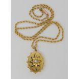 A VICTORIAN STAR PENDANT set with a central split pearl in an enamelled and cut back bright yellow