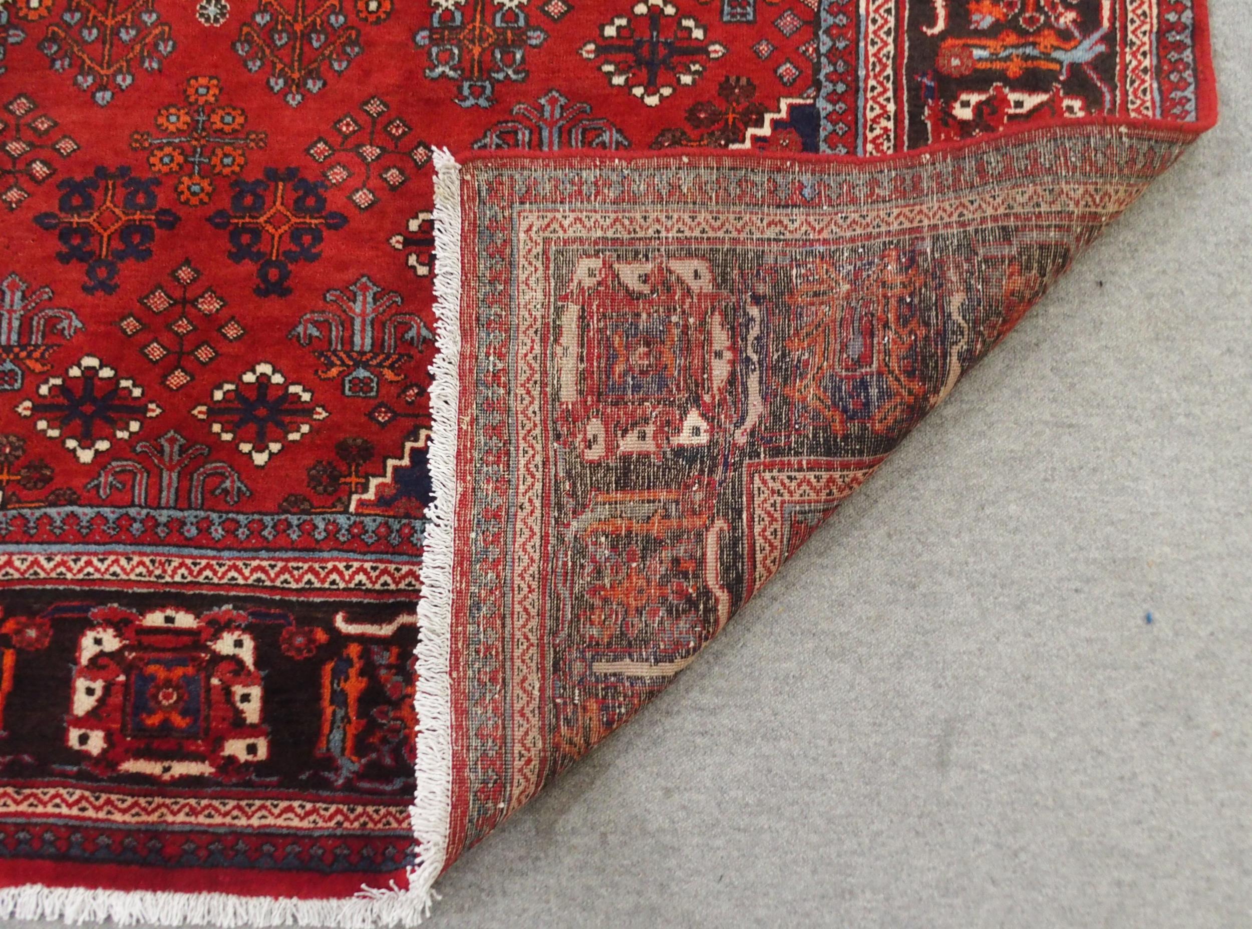 A RED GROUND MEIMEH RUG with dark blue central medallion, matching spandrels and dark blue flower - Image 9 of 10