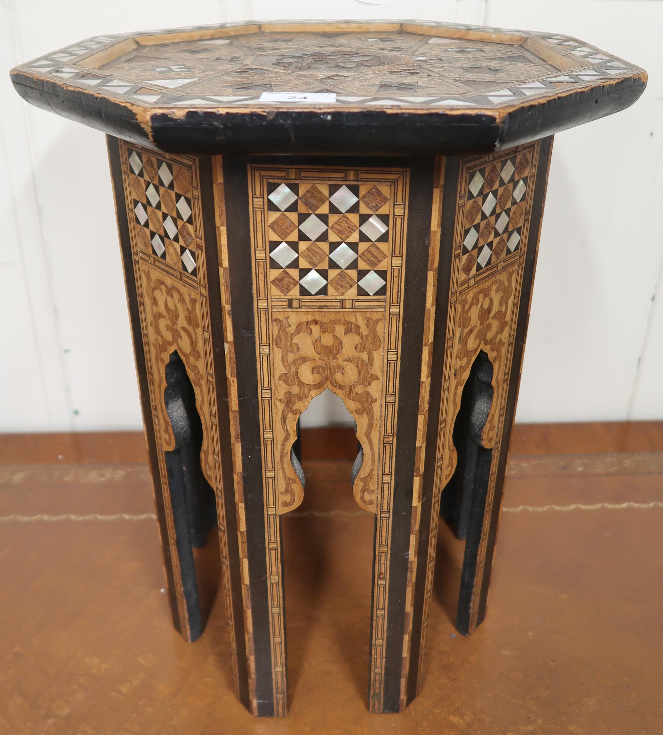 An Anglo-Moorish occasional table in the manner of Liberty & Co with mother of pearl and sample wood