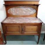 A late Victorian mahogany washstand with pink marble top and splashback over pair of cabinet doors