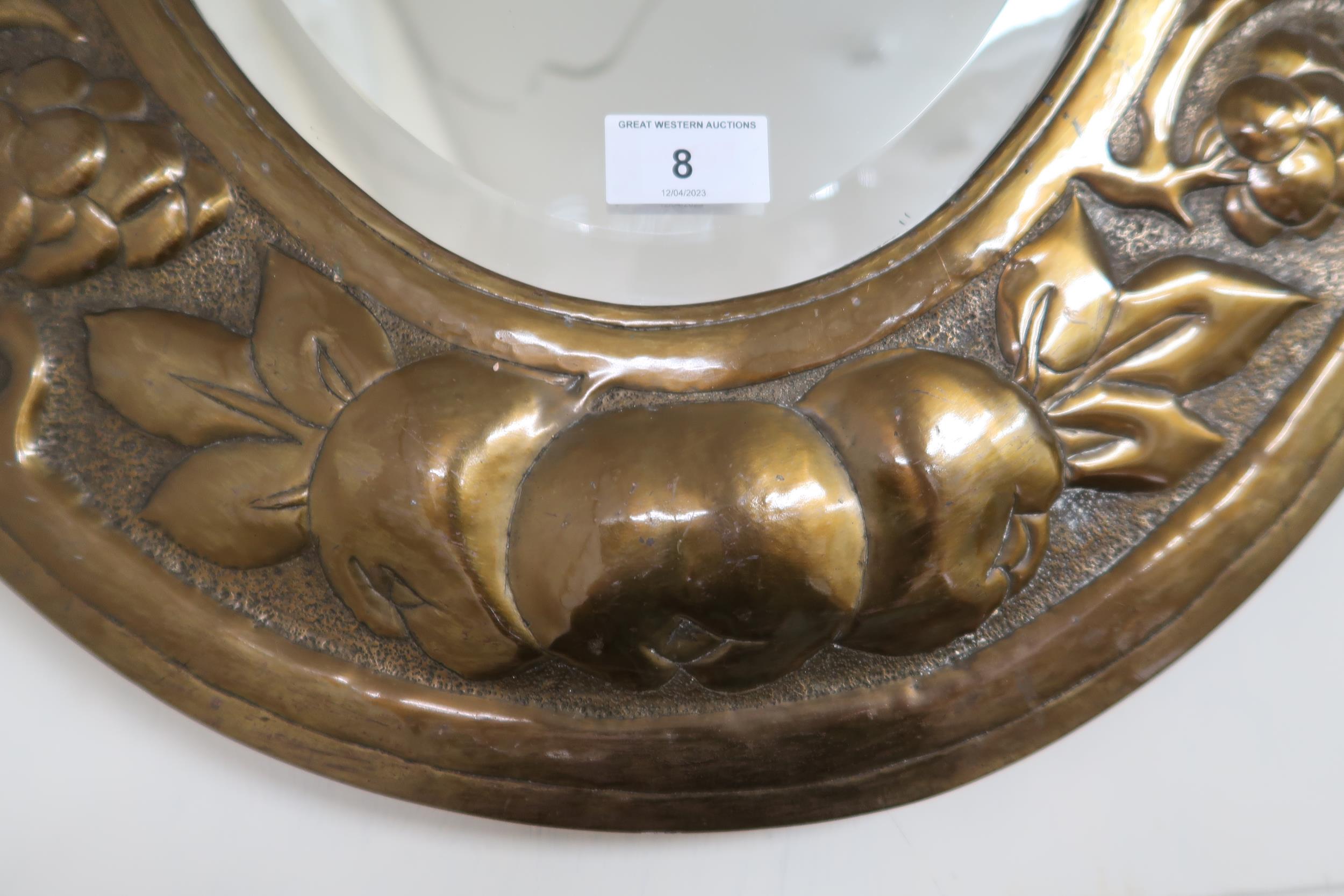 An early 20th century oval brass framed bevelled glass wall mirror with embossed fruit on the vine - Image 2 of 3