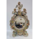 A continental cherub mounted mirror with applied flowers Condition Report:Available upon request