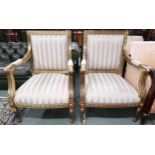 A pair of 20th century gilt framed continental style open armchairs with striped upholstery, 96cm