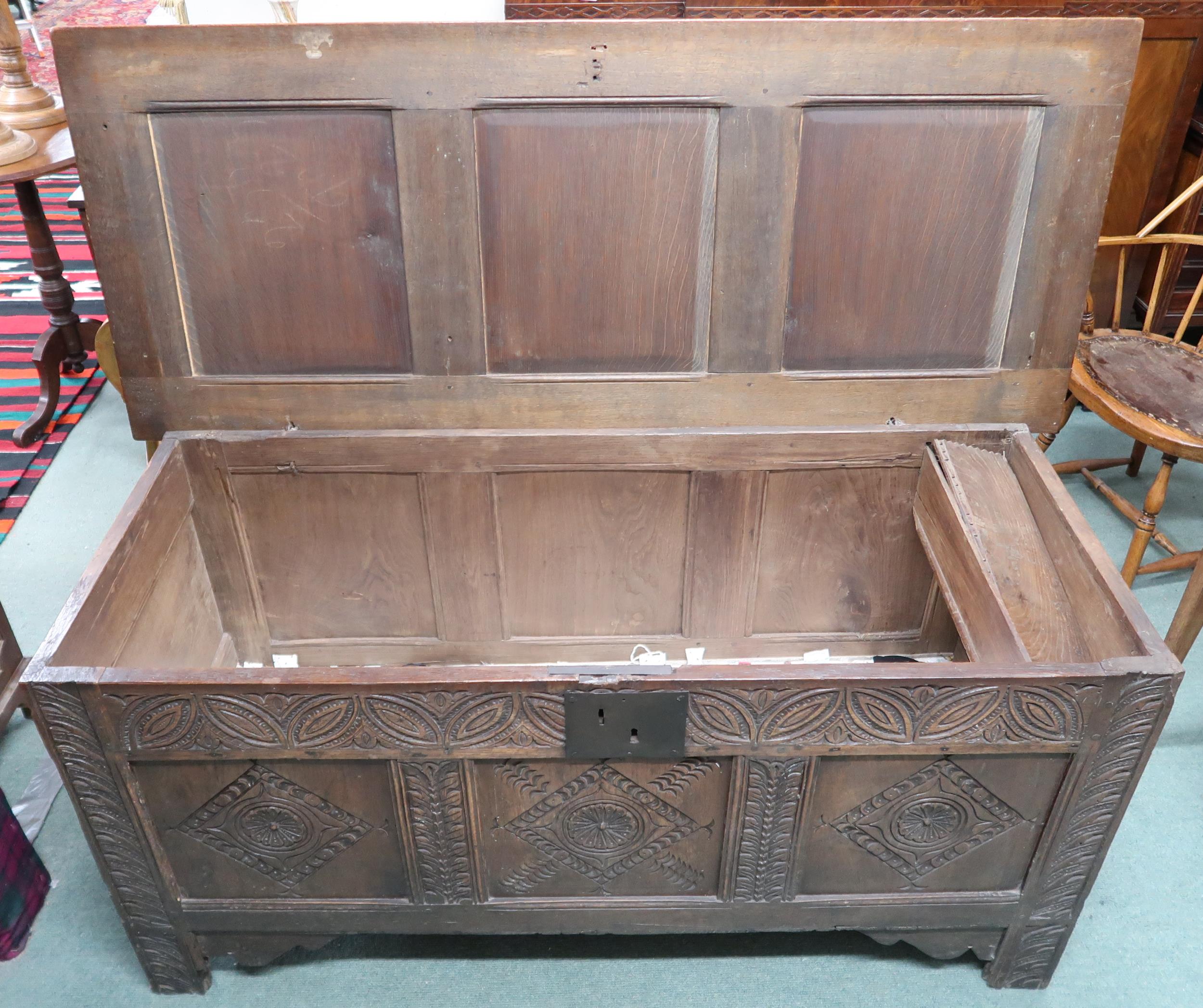 An 18th century oak blanket chest with carved panel front, 71cm high x 151cm wide x 63cm deep - Image 3 of 3