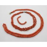 Two coral bead necklaces, a round and barrel bead example, length approx 90cm, with a short