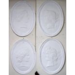 A set of four oval plaster wall plaques each with cameo style silhouettes in the guise of the four