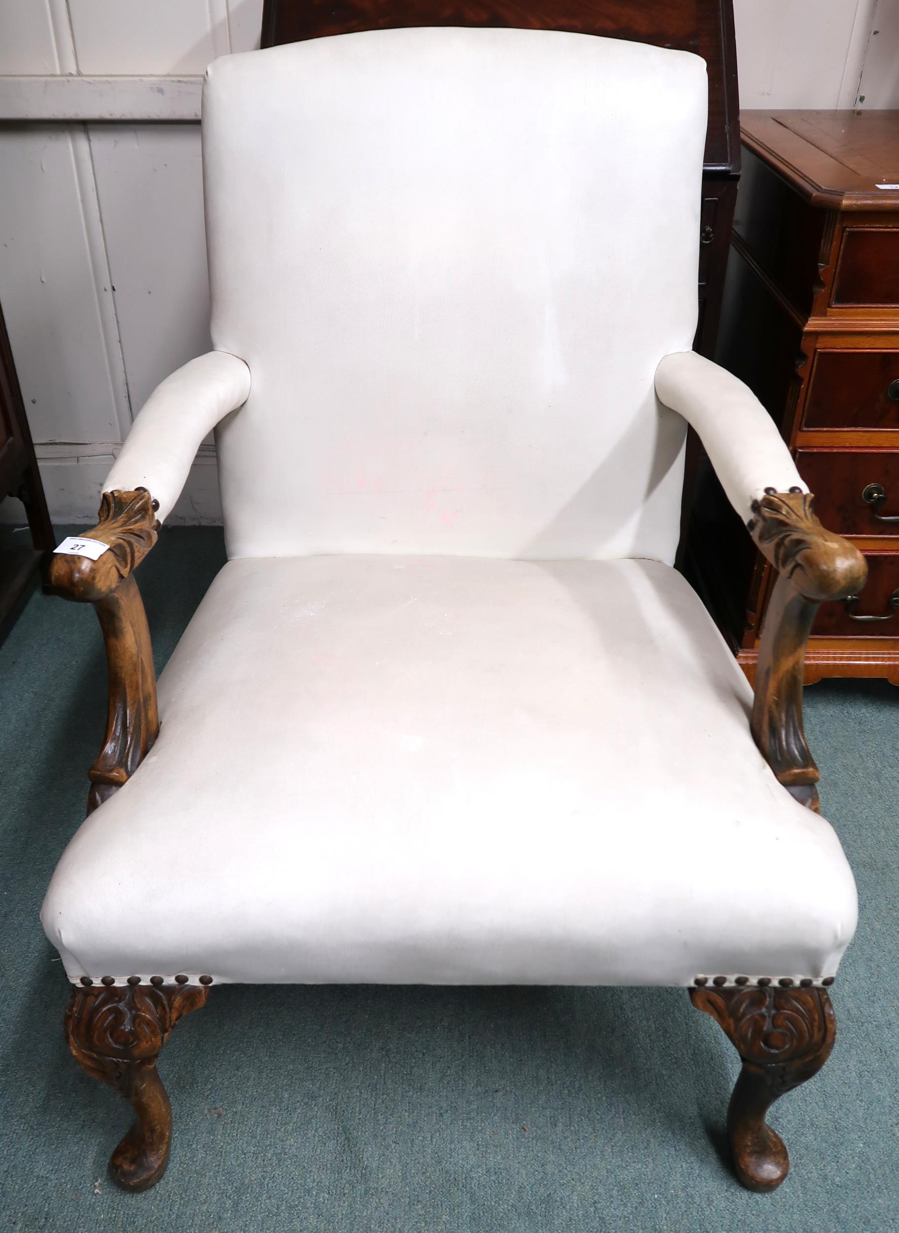 An early 20th century open armchair with white vinyl upholstery on carved cabriole supports, 93cm