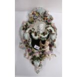 A continental cherub and flower decorated wall mirror with candle arms Condition Report:Available