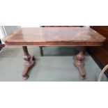 A Victorian rosewood library table with single drawer on octagonal baluster supports on bun feet,
