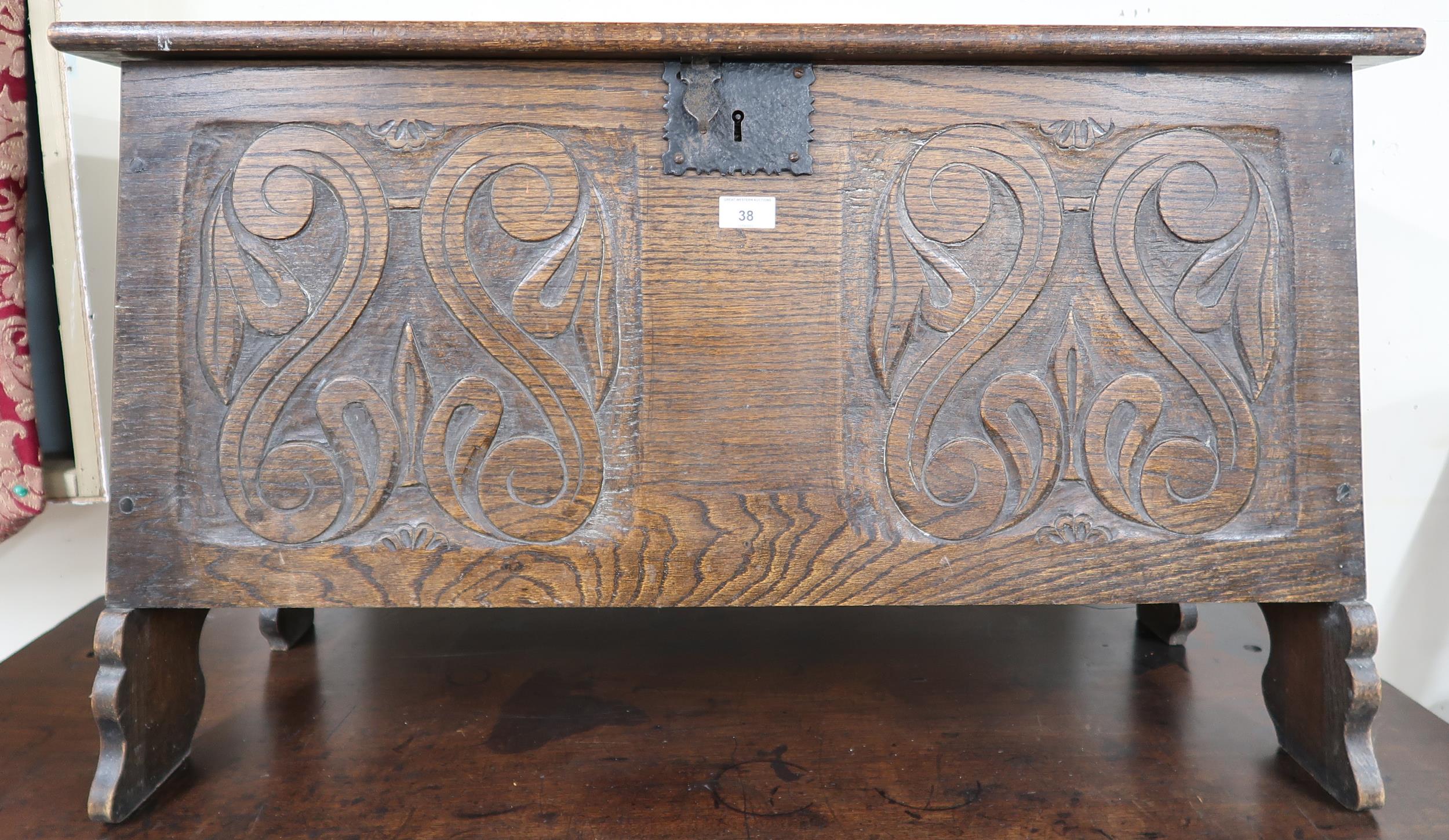 A 20th century oak kist with carved front panel, 56cm high x 91cm wide x 42cm deep Condition