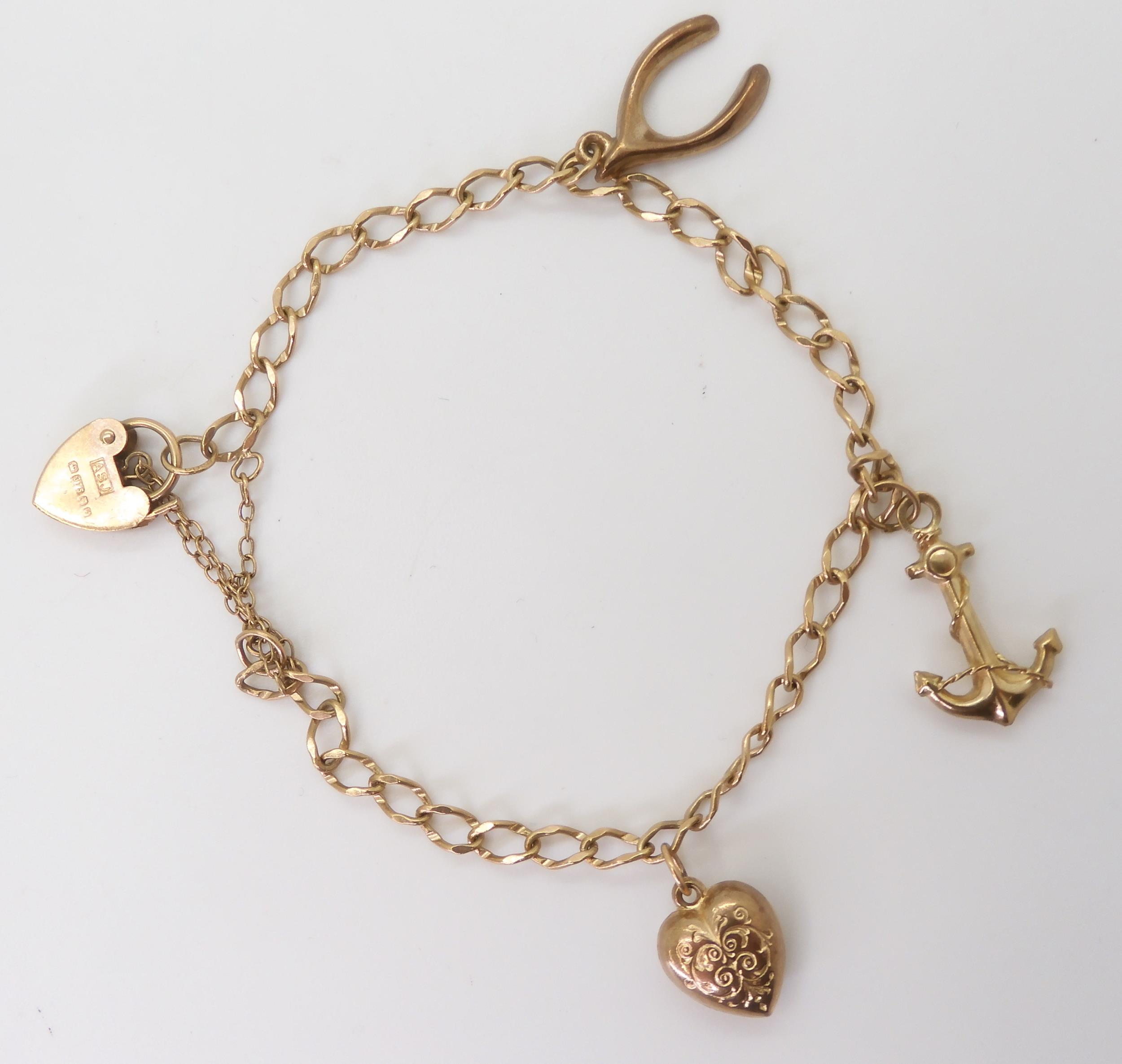 A 9ct gold charm bracelet, with heart clasp and three attached hollow charms one hallmarked, - Image 3 of 3