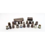 A collection of silver and white metal thimbles, including guilloche enamel continental examples,