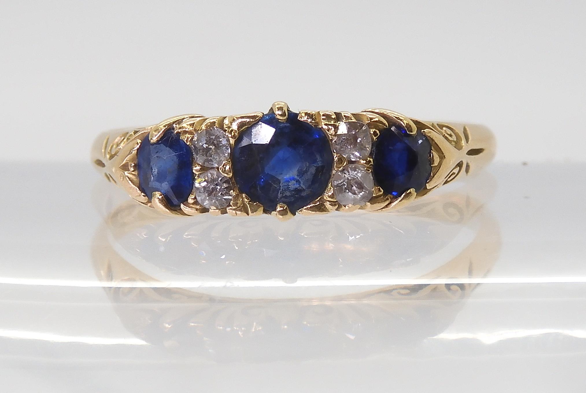 A yellow metal sapphire and diamond ring, in a classic scroll mount, finger size U1/2, weight 3.3gms