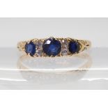 A yellow metal sapphire and diamond ring, in a classic scroll mount, finger size U1/2, weight 3.3gms