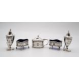 A George V five piece silver cruet set, comprising two open salts, a mustard pot, and a salt and