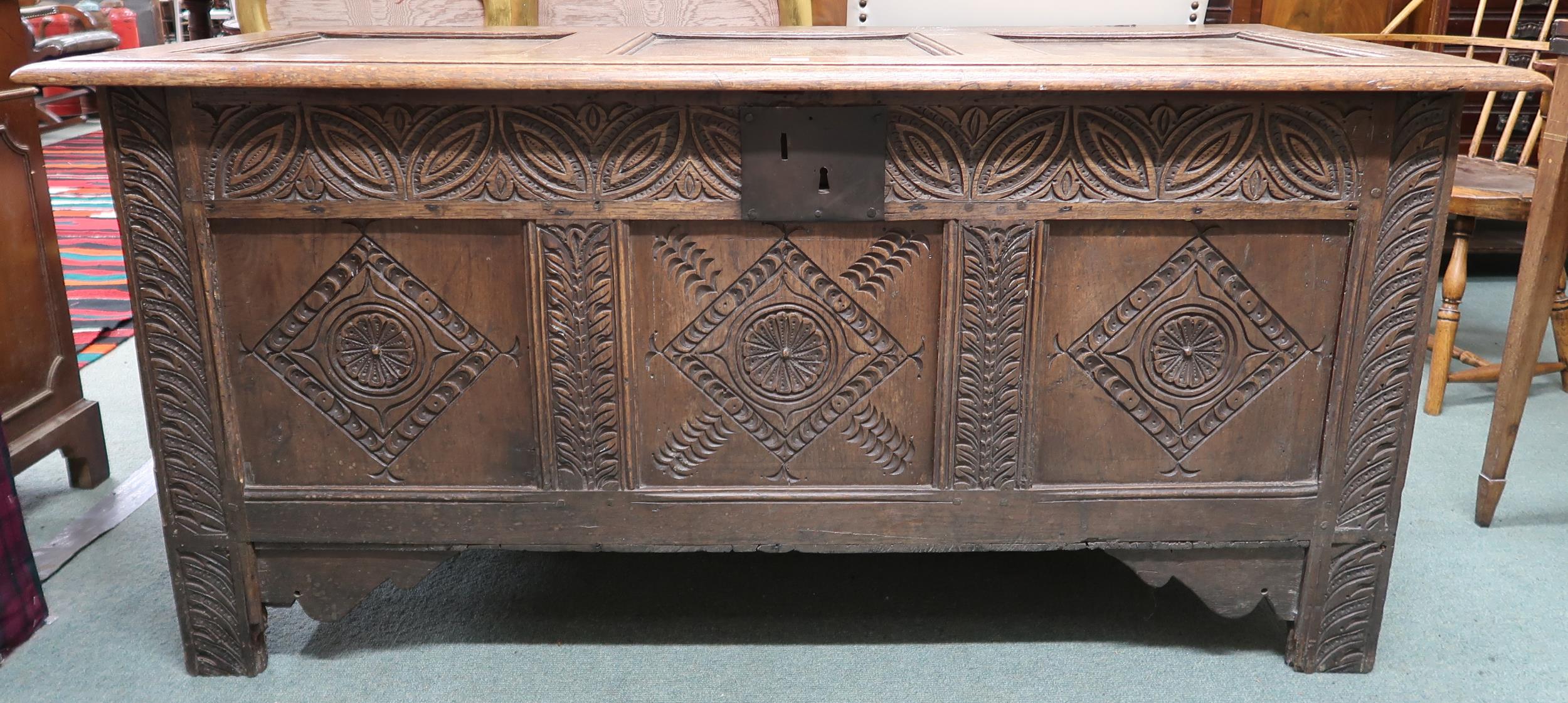 An 18th century oak blanket chest with carved panel front, 71cm high x 151cm wide x 63cm deep