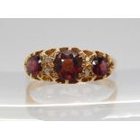 An 18ct gold garnet and diamond accent ring, size R, weight 3.5gms Condition Report:Garnets highly