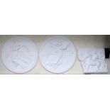 A pair of circular plaster wall plaques depicting angels in flight, 92cm diameter and another