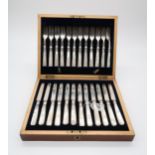 A cased oak canteen of Edwardian silver mother of pearl handled fish knives and forks, by