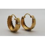 A pair of 18ct gold hoop earrings with white gold star design, approx diameter 2.2cm, weight 4.