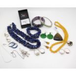A honey jade necklace and earrings, a Russian diopside silver snake ring, a lapis lazuli, necklace