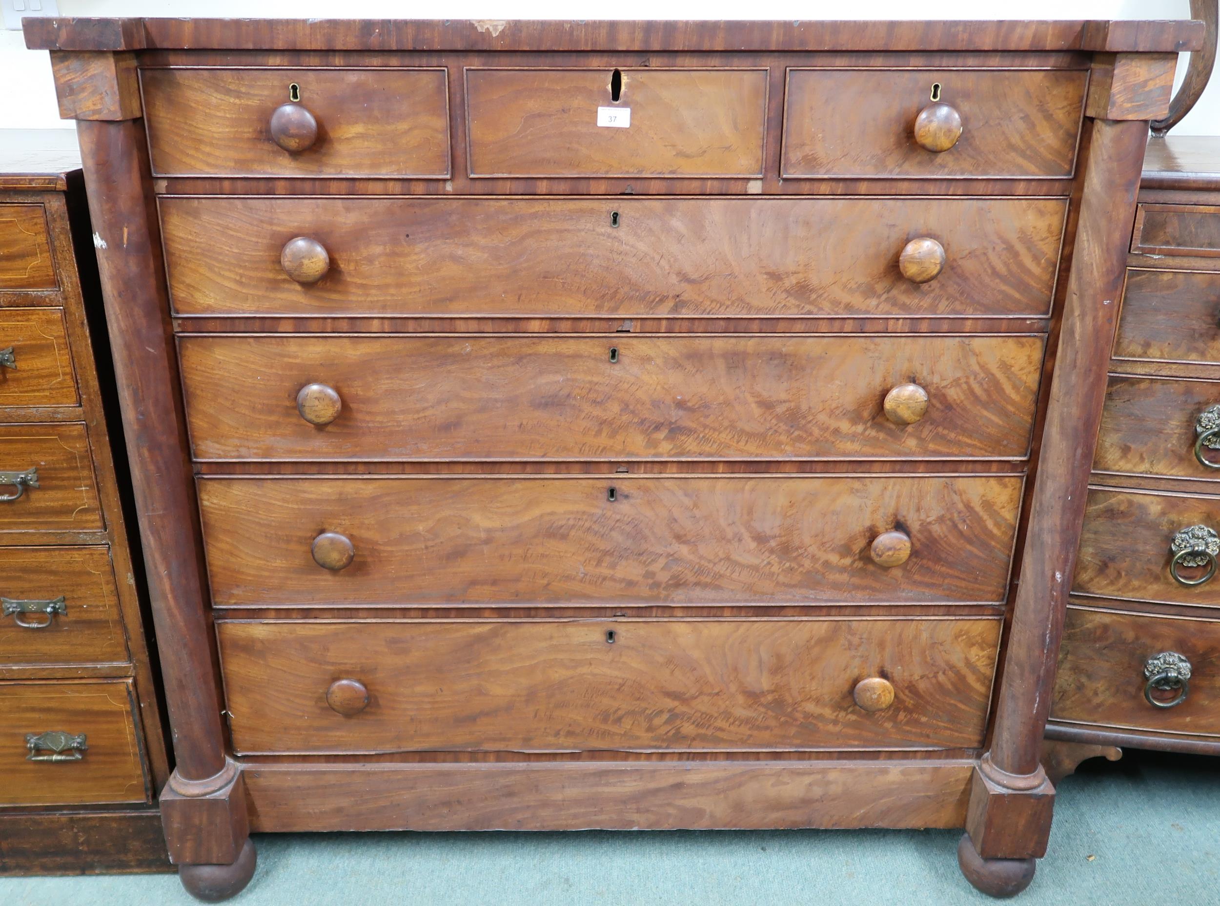 A Victorian mahogany chest of drawers with three short over four long drawers flanked by columns