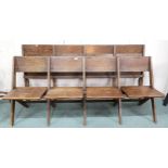 A pair of early 20th century oak four seat folding pews with shaped seats, 78cm high x 187cm wide