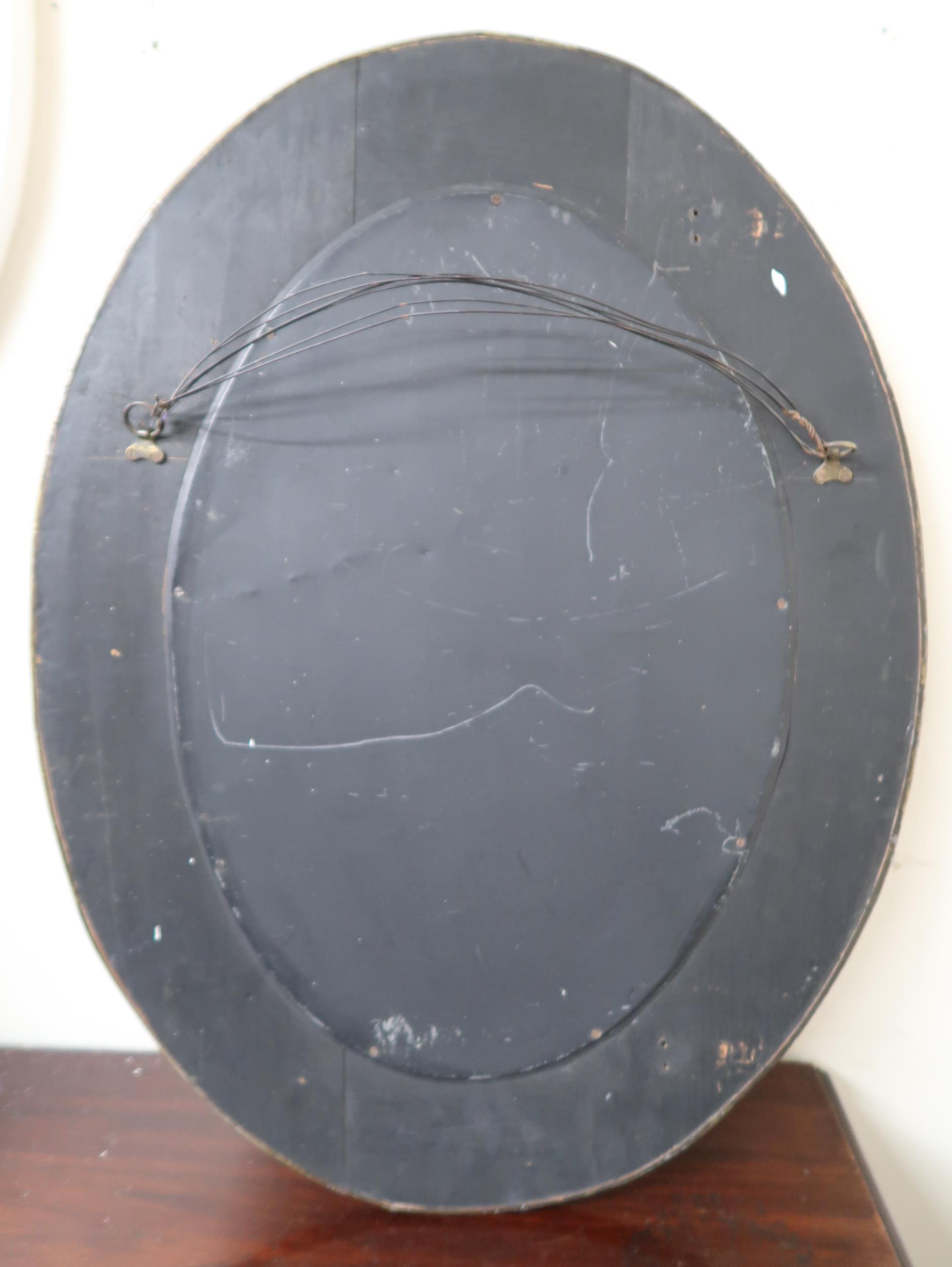 An early 20th century oval brass framed bevelled glass wall mirror with embossed fruit on the vine - Image 3 of 3