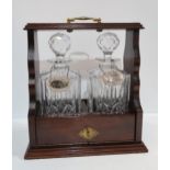 A two bottle tantalus with silver labels Condition Report:Available upon request