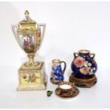 A miniature Dunmore tankard, 1cm high, a miniature Royal Crown Derby cup and saucer, miniature