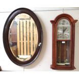 A 20th century mahogany cased Tempus Fugit wall clock and an oval Victorian wall mirror (2)