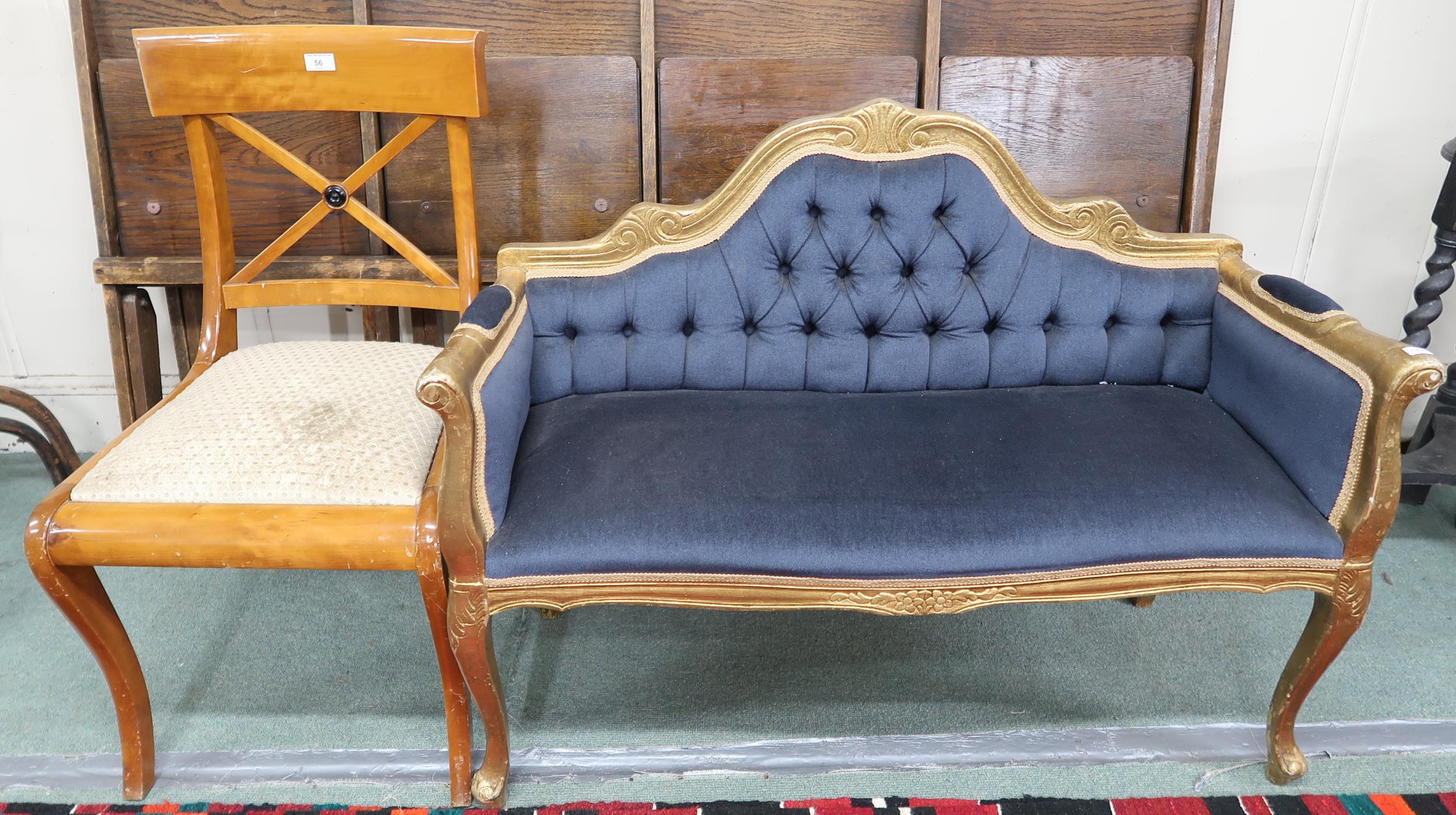 A 20th century gilt framed window seat with blue button back upholstery and a sabre leg dining chair