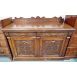 A Victorian oak sideboard with pair of carved drawers over pair of carved doors on plinth base, 99cm