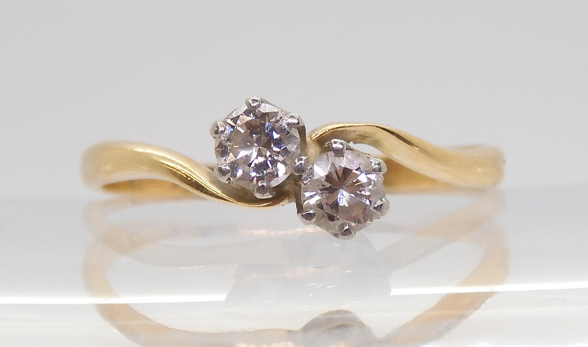 An 18ct gold twin stone diamond ring set with an estimated approx 0.33cts of brilliant cut