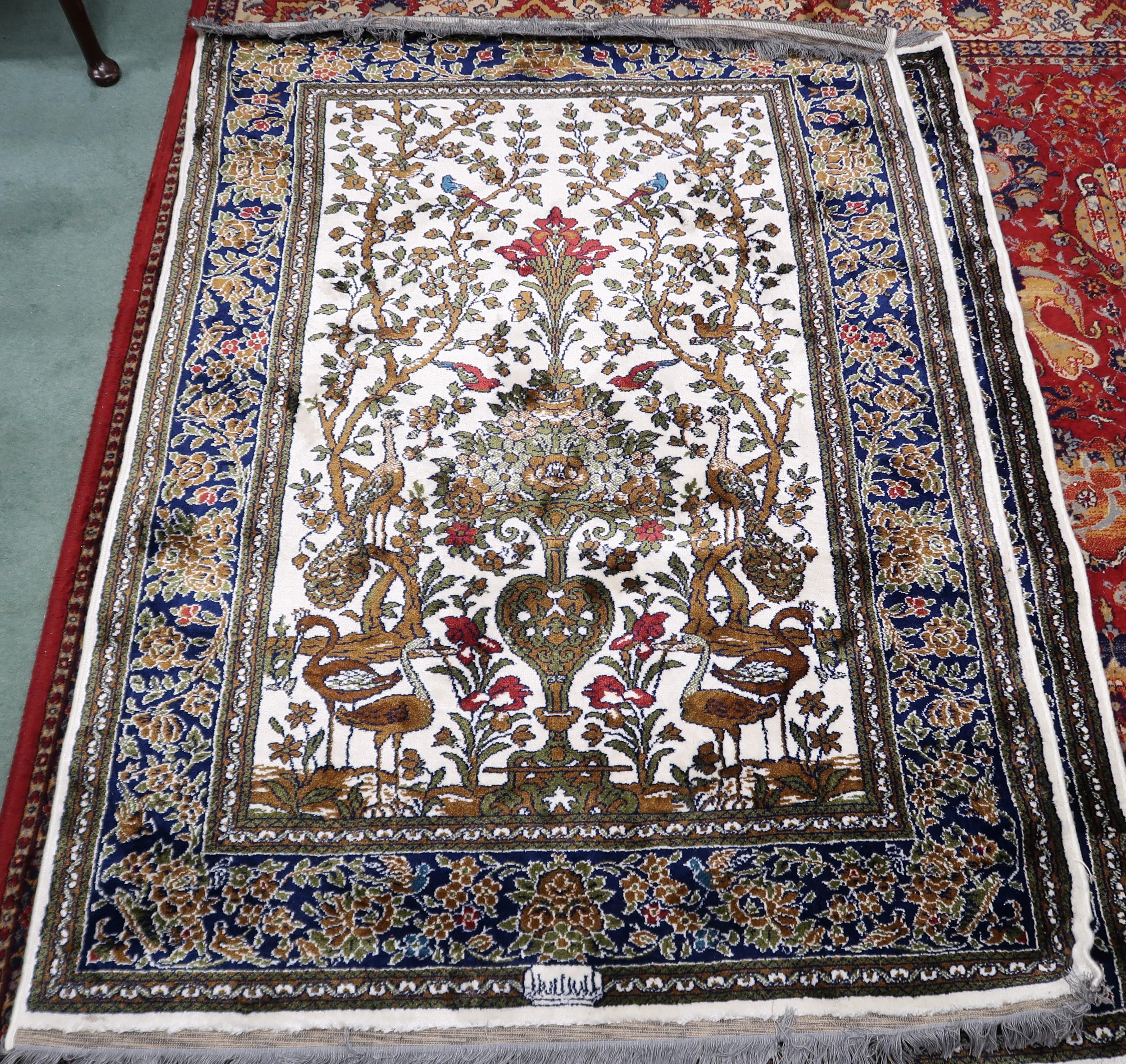 A pair 20th century wool tree of life pattern rugs with floral foliate border, 180cm long x 133cm