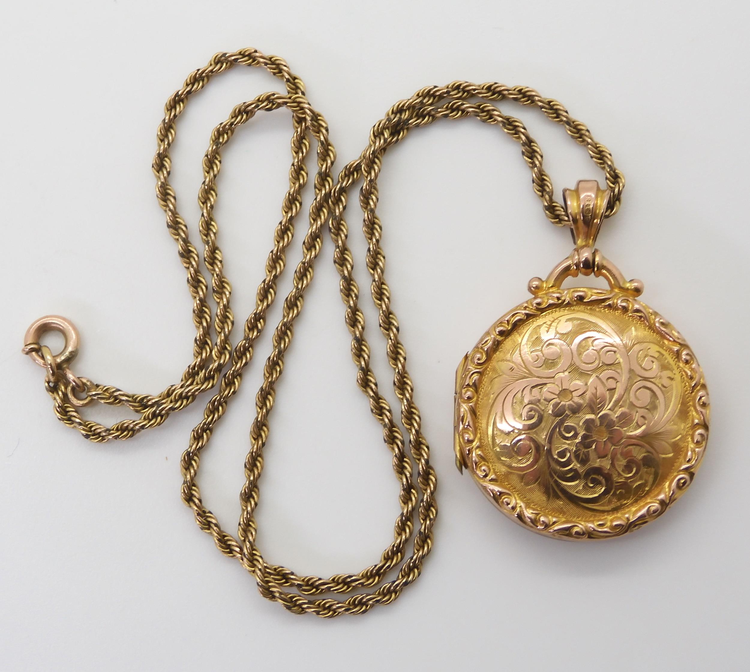 A 9ct gold circular locket hallmarked Birmingham 1911, monogram to the back, with a yellow metal
